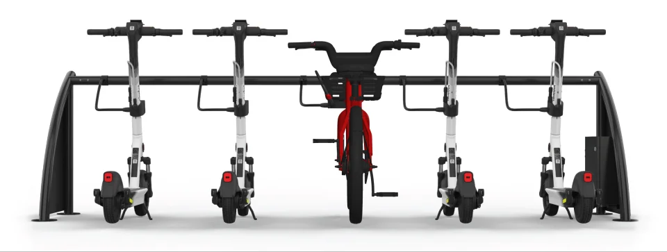 A docking and charging station with both scooters and ebikes, each connected to the station via a single ChargeLock cable