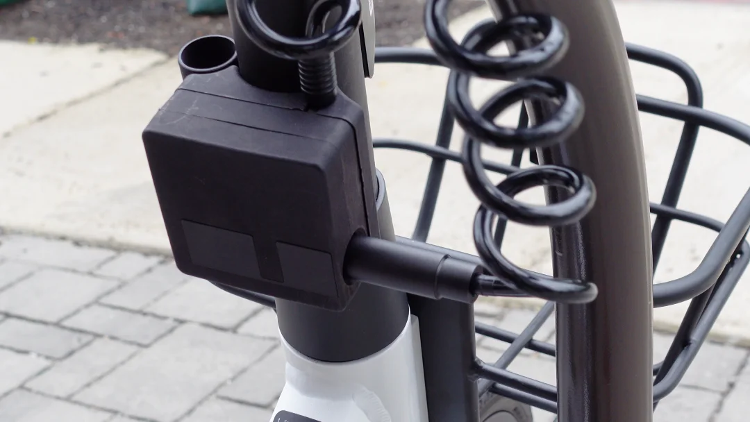 On-board cable lock on the e-bike secured around a bike rack