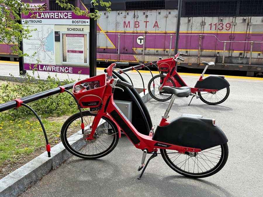 Metro Mobility E-Bikes in front of MBTA Commuter Rail train