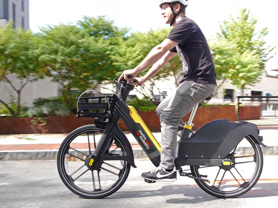 Man riding Metro Mobility e-bike for errands